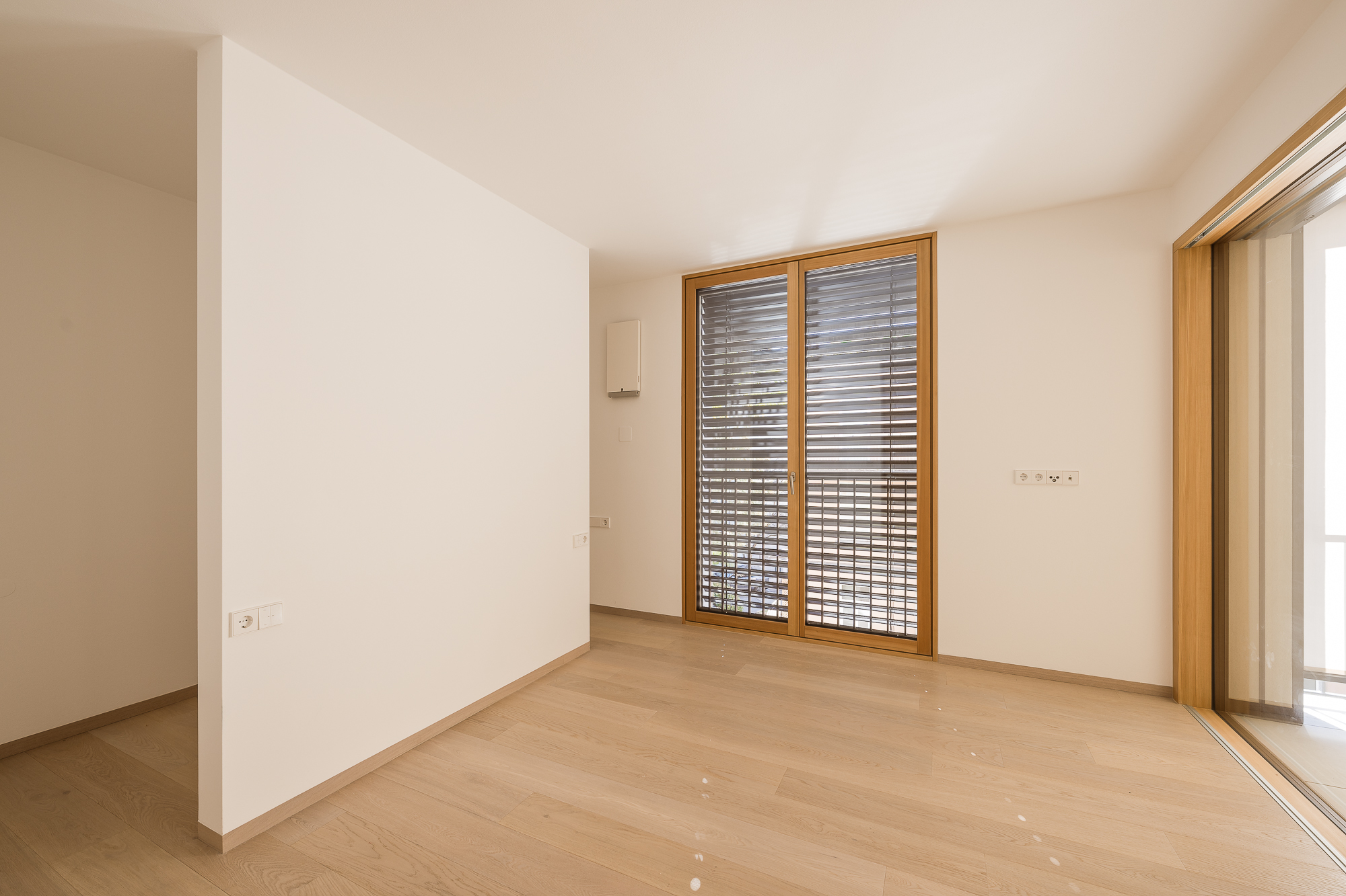 Lichtdurchflutetes Zimmer mit raumhohen Fenstern